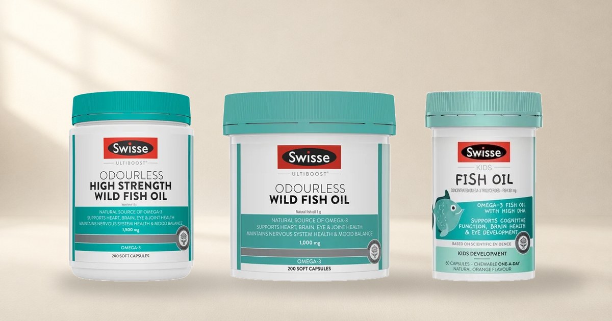 Three Swisse omega-3 bottles standing on a cream studio floor, the high strength wild fish oil, the odourless 1000mg and the one made for children